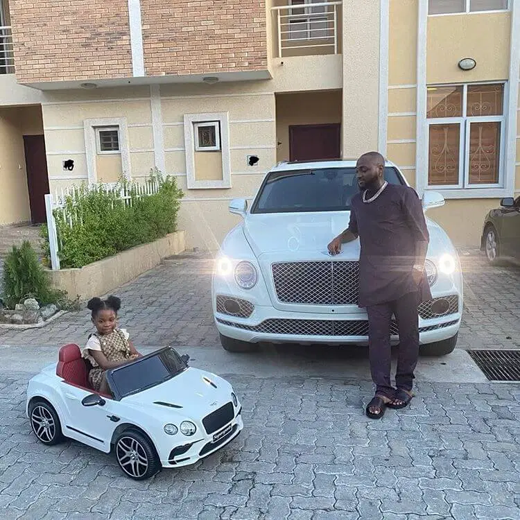 Davido Silently Bought New Bentley Bentayga Or He Repainted His Old White Bentley To All Black? 1 Davido Bentley Bentayga car with daughter